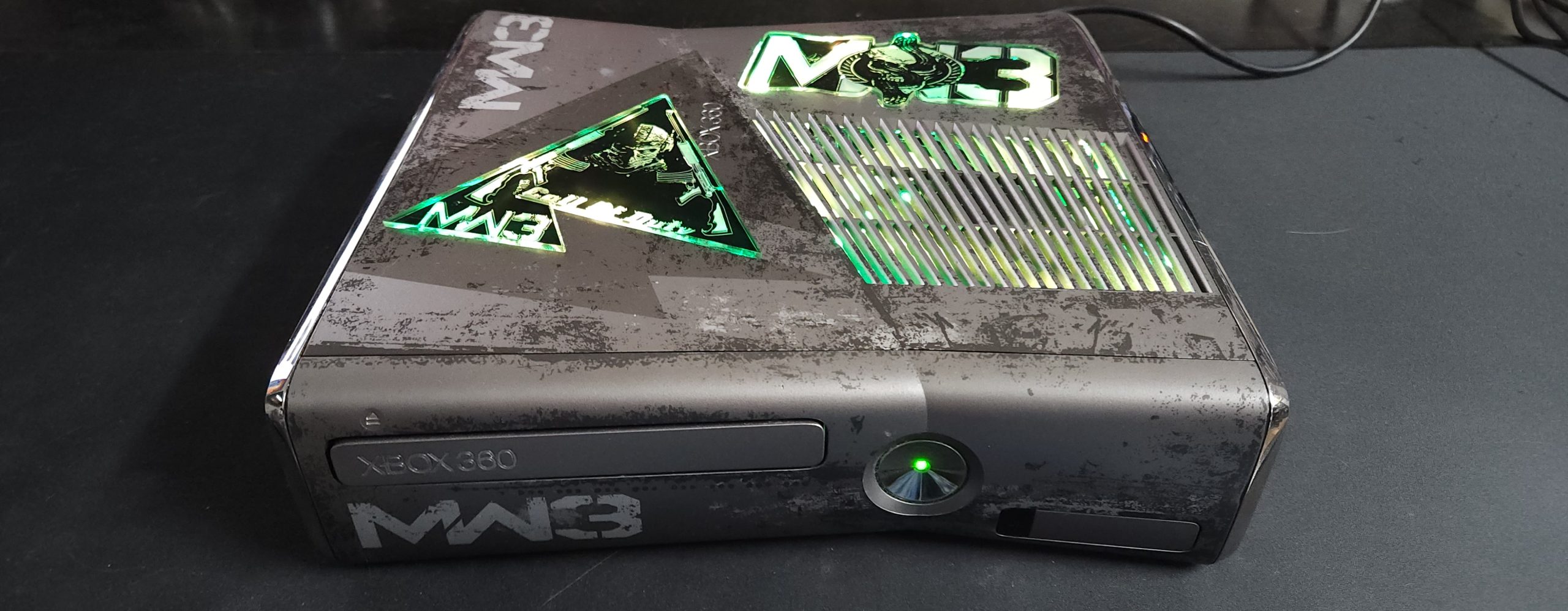 Modern Warfare 3 Special Edition console with custom laser-etched glass and remote LEDs.